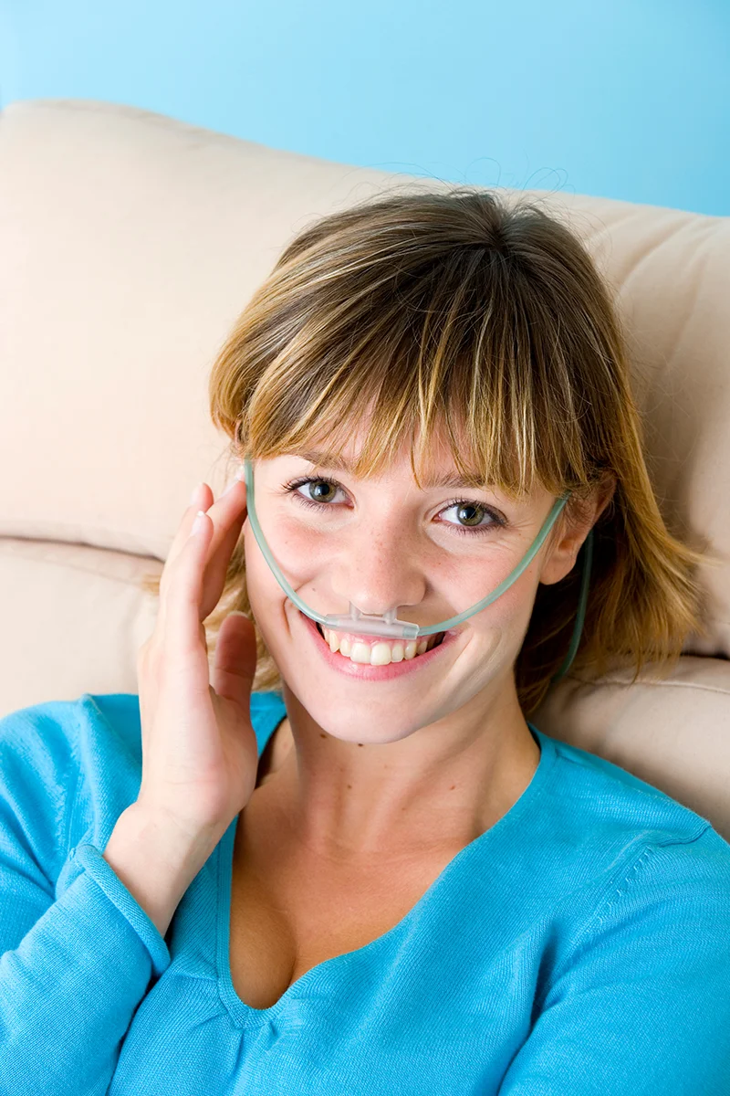 Smiling woman with oxygen mask